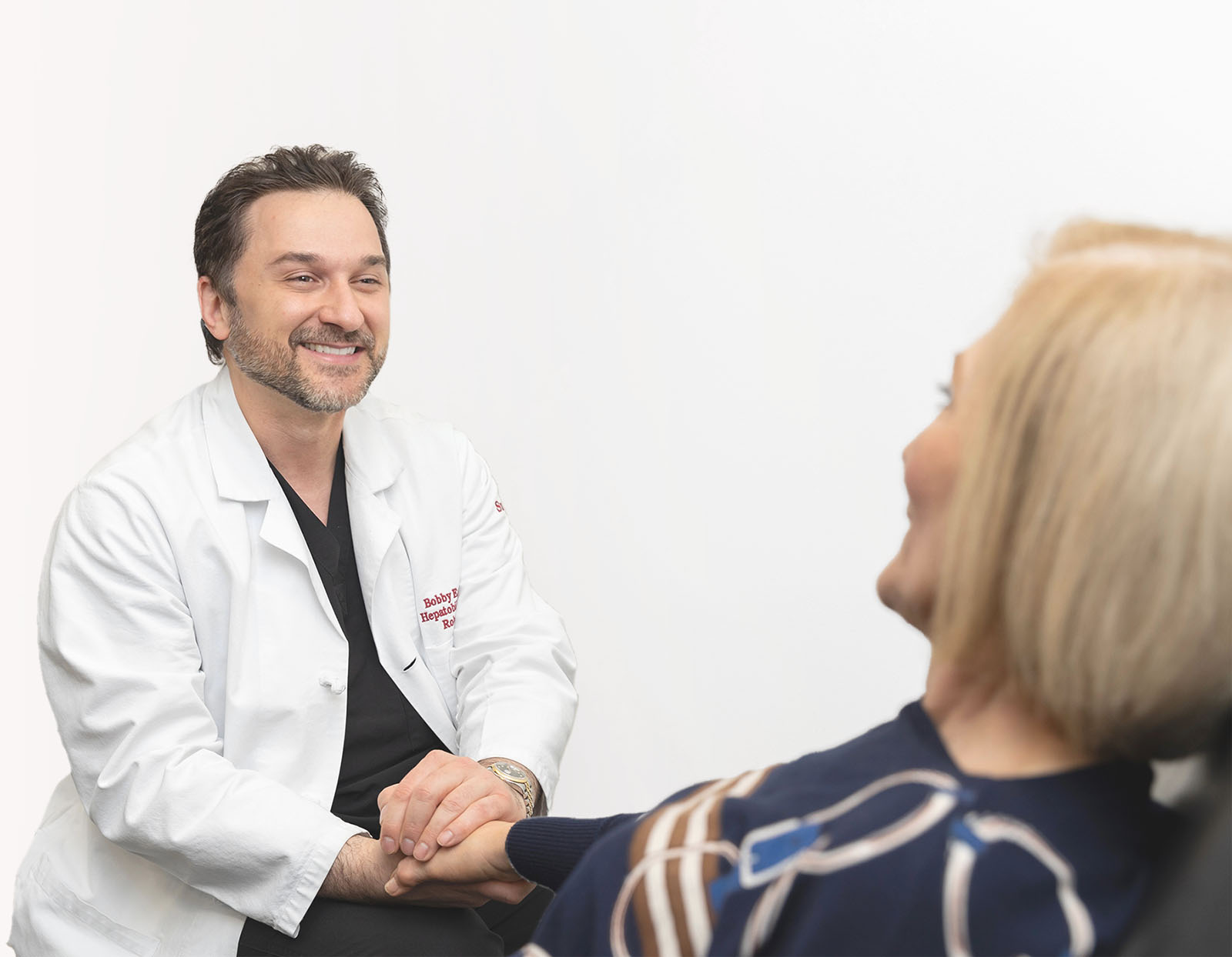 Dr. Babak Eghbalieh comforting a patient at SCMSC