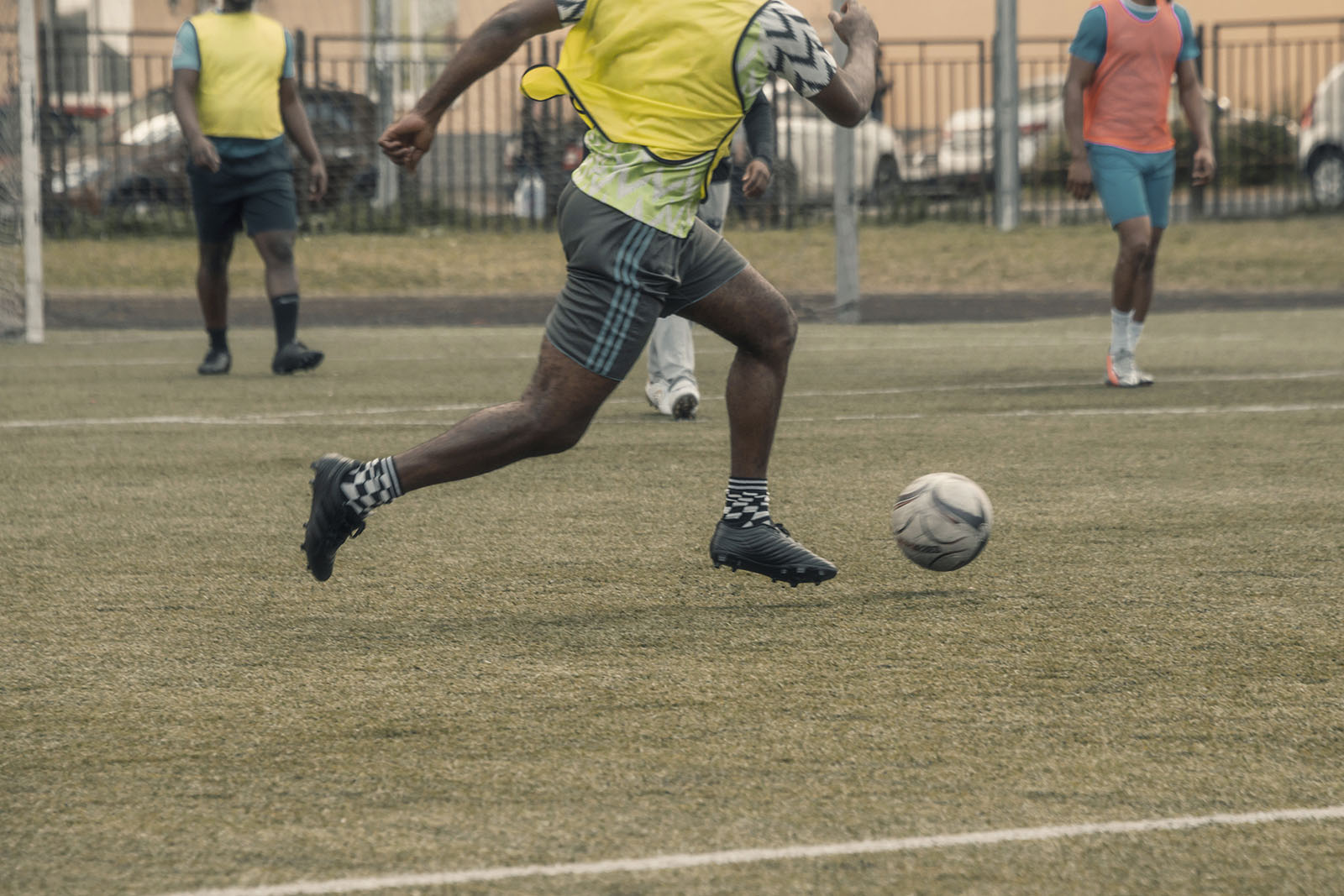 soccer player running down field with soccer ball showing how easy it is to incur a foot or ankle injury in sports