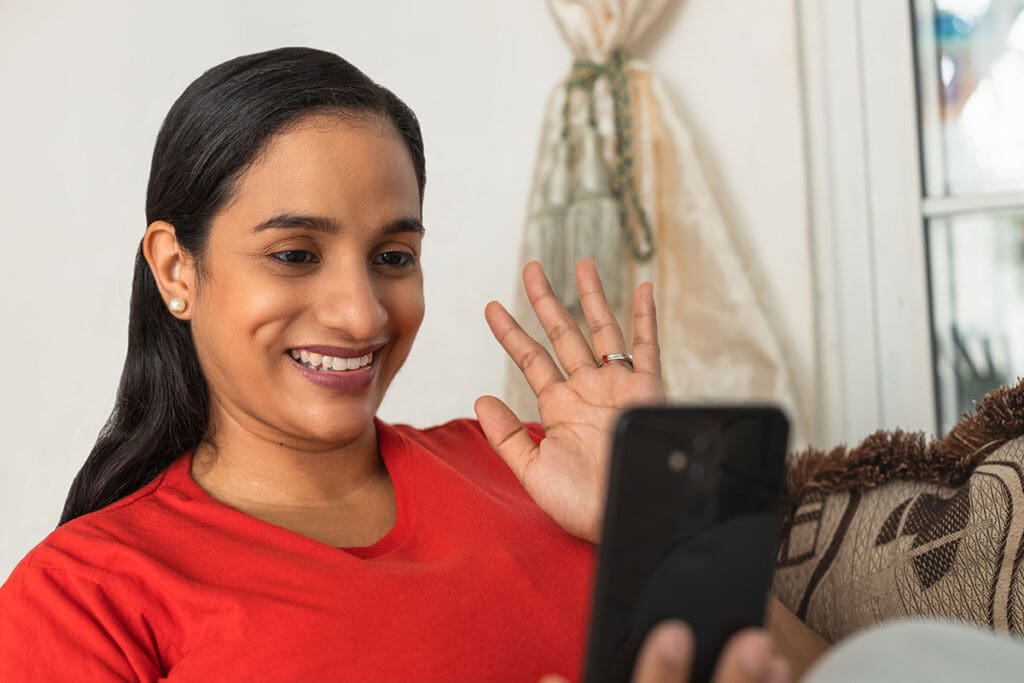 Woman meets with her doctor using her mobile phone from the comfort and convenience of home