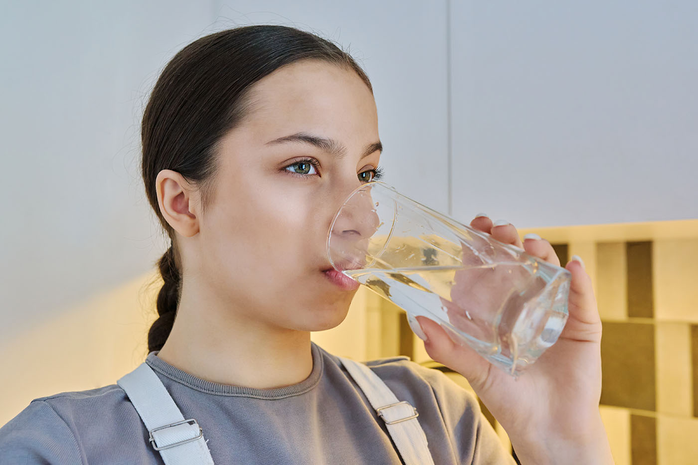 young woman drinking a glass of water
