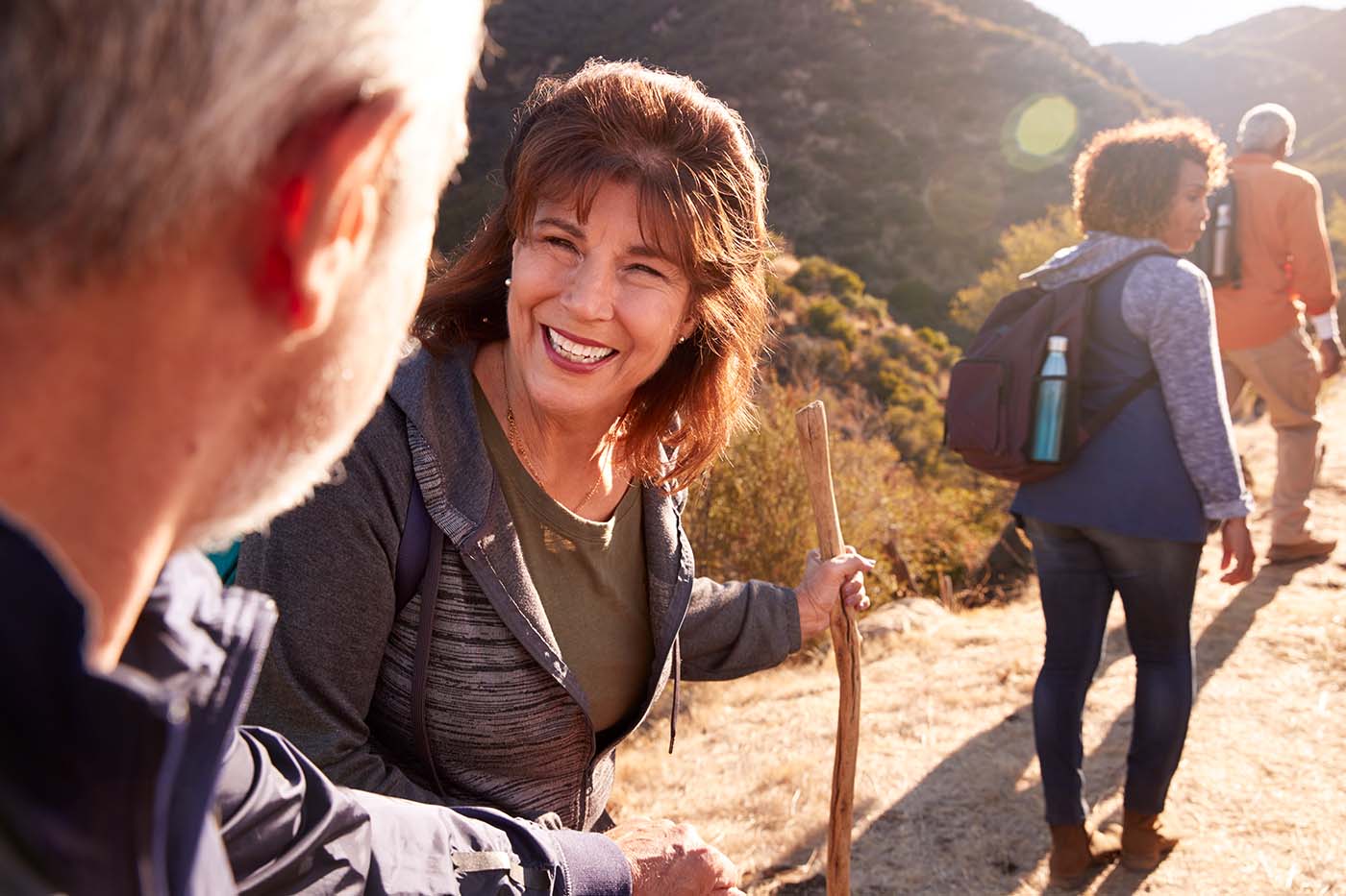 group of adult friends enjoy a morning hike