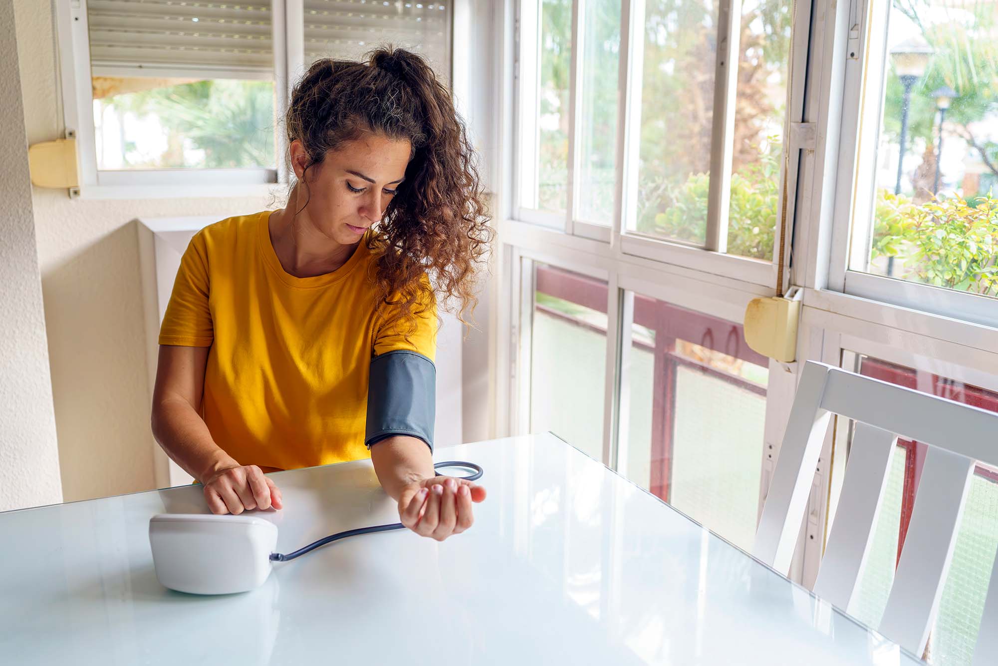 Magnesium supplementation can help lower blood pressure woman checks her blood pressure at home